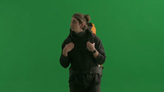A Walking Male Tourist with a Hiking Backpack on His Back Stops and Waves His Hand in Greeting When. A walking male tourist with a hiking backpack on his back, stops and waves his hand in greeting when he sees his acquaintances. A man hiker in the st