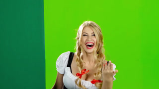 Girl in Bavarian Costume Lures To Their Hand and Showing the Thumb. Green Screen