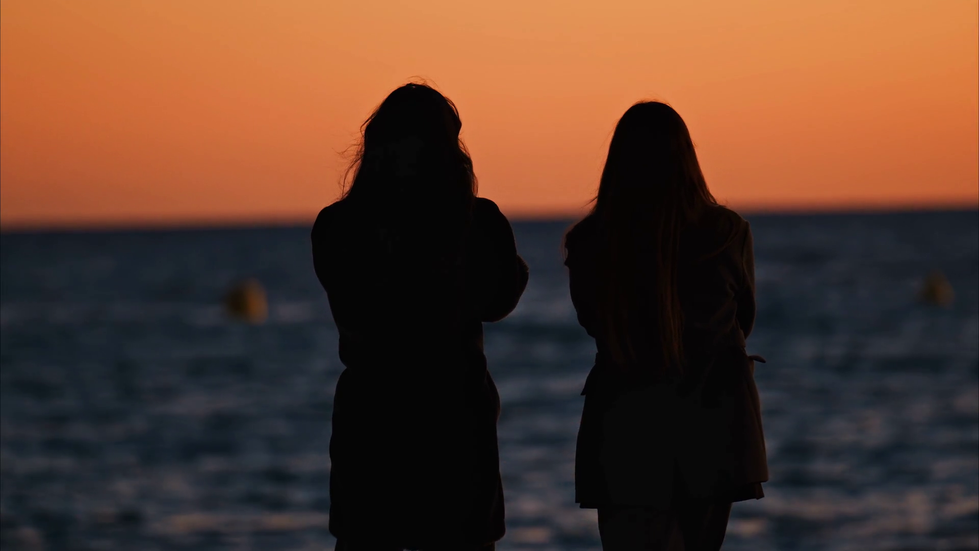 Two Women On Beach Looking At Sea At Sunset Stock Footage SBV-352202052 ...