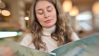 Brunette woman looking through the menu in a restaurant