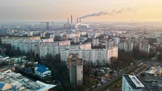 Cityscape of Bucharest from a drone, hyperlapse, rows of residential buildings, thermal station with fog getting out, cloudy weather, busy roads, ecology idea, Romania