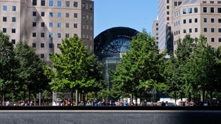 NEW YORK, USA - SEPTEMBER 25, 2019: Tourists take photos near Memorial Fountain in sunlight. Bottom view