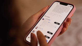 Chisinau, Moldova - November 22, 2022: Woman opening up and scrolling on Twitter on her phone