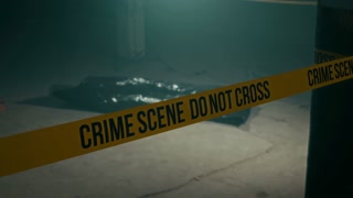 No people low-key shot of crime scene yellow barricade at murder scene with dead body under black plastic bag on ground in abandoned building
