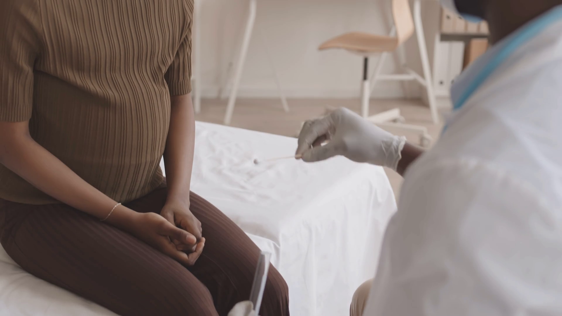 Slowmo shot of young AfricanAmerican pregnant woman being taken swab