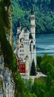 Aerial view of the fairytale Neuschwanstein Castle atop a mountain in a picturesque valley, Germany
