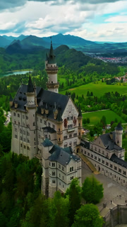 Aerial view of the fairytale Neuschwanstein Castle atop a mountain in a picturesque valley, Germany