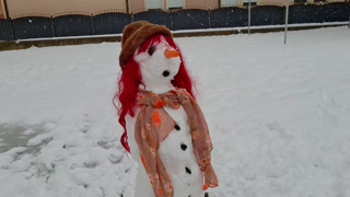 Female Snowman With Cool Red Hair In Snow