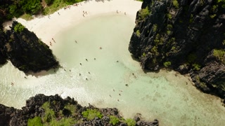 Aerial drone of tropical lagoon with sandy beach surrounded by cliffs. El nido, Philippines, Palawan. beautiful lagoon and karst scenery.