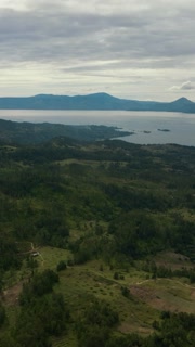 Top view of Lake Toba and the island of Samosir with houses on the shore. Sumatra, Indonesia. Vertical video.