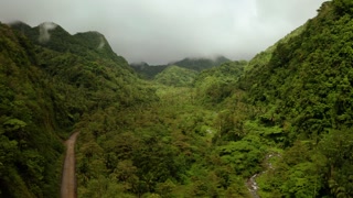 Mountain landscape on tropical island with mountain peaks covered with forest. Slopes of mountains with evergreen vegetation. Camiguin, Philippines.