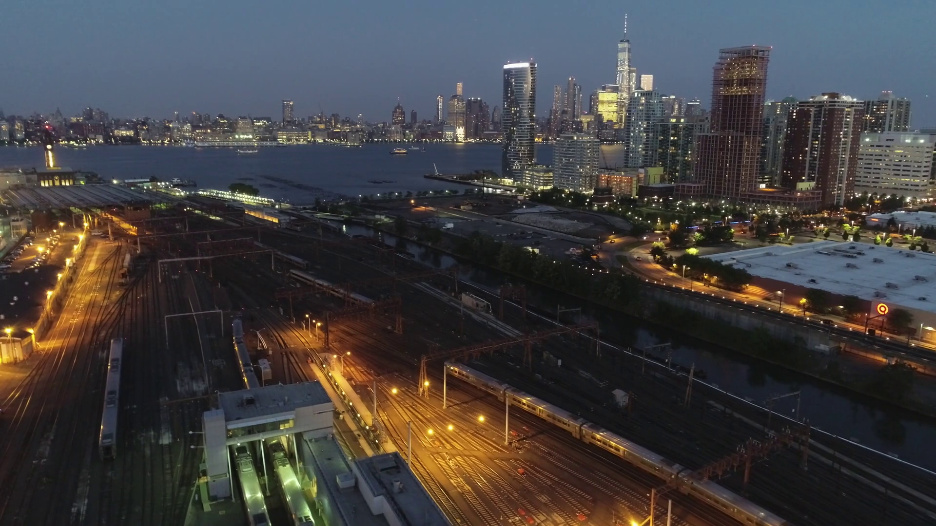 Flyover Aerial of Jersey City Train Station, New Jersey at Night Stock