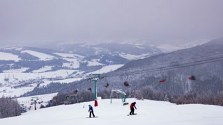 Ski lift, skiers and snowboarders, resort in Carpatian mountains, time lapse