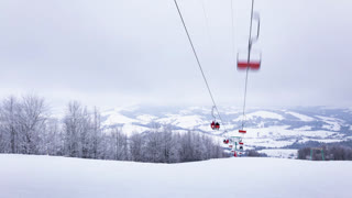 Ski lift, skiers and snowboarders, resort in Carpatian mountains, time lapse