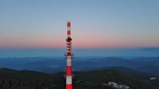 Tower Snezhana on peak of Snezhana covered with spruce forests in Rhodope mountains