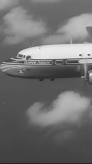 1954 - A vintage old Pan American commerical propellor plane is seen in flight.