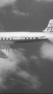 1954 - A vintage old Pan American commerical propellor plane is seen in flight.