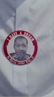 1968 - Participants in the Poor People's March on Washington march past the camera, some of them wearing pins with Martin Luther King on them.