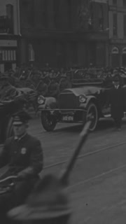 1917 - American soldiers accompany President Wilson's motorcade in a Labor Day parade.