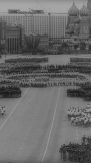 1966 - Troops pass in review and children perform folk dances in a May Day celebration held in Red Square of Moscow, Russia.