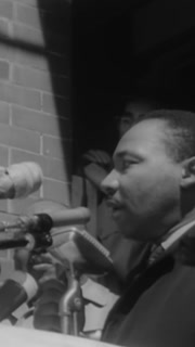 1965 - Martin Luther King addresses people gathered in Selma, Alabama for the Freedom March and they are surrounded by state troops on their departure.