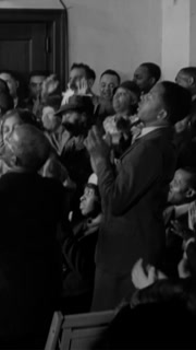 1935 - Elder Lightfoot Solomon Michaux leads his church's choir and congregation in song in Washington DC.