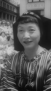 1960 - Film stars Anna May Wong and Virginia Grey attend a fashion show coinciding with the Chicago premiere of their film, "Portrait in Black."