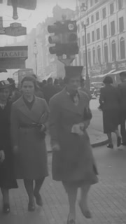 1940 - Supporters of fascist Oswald Mosley pass out antiwar flyers to pedestrians in London, England, urging reconciliation with Hitler in the name of peace.