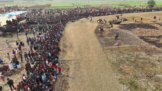 Mohanpur, Bangladesh - 19 February 2022: Aerial view of many people watching traditional horse race in Mohanpur, Bangladesh.