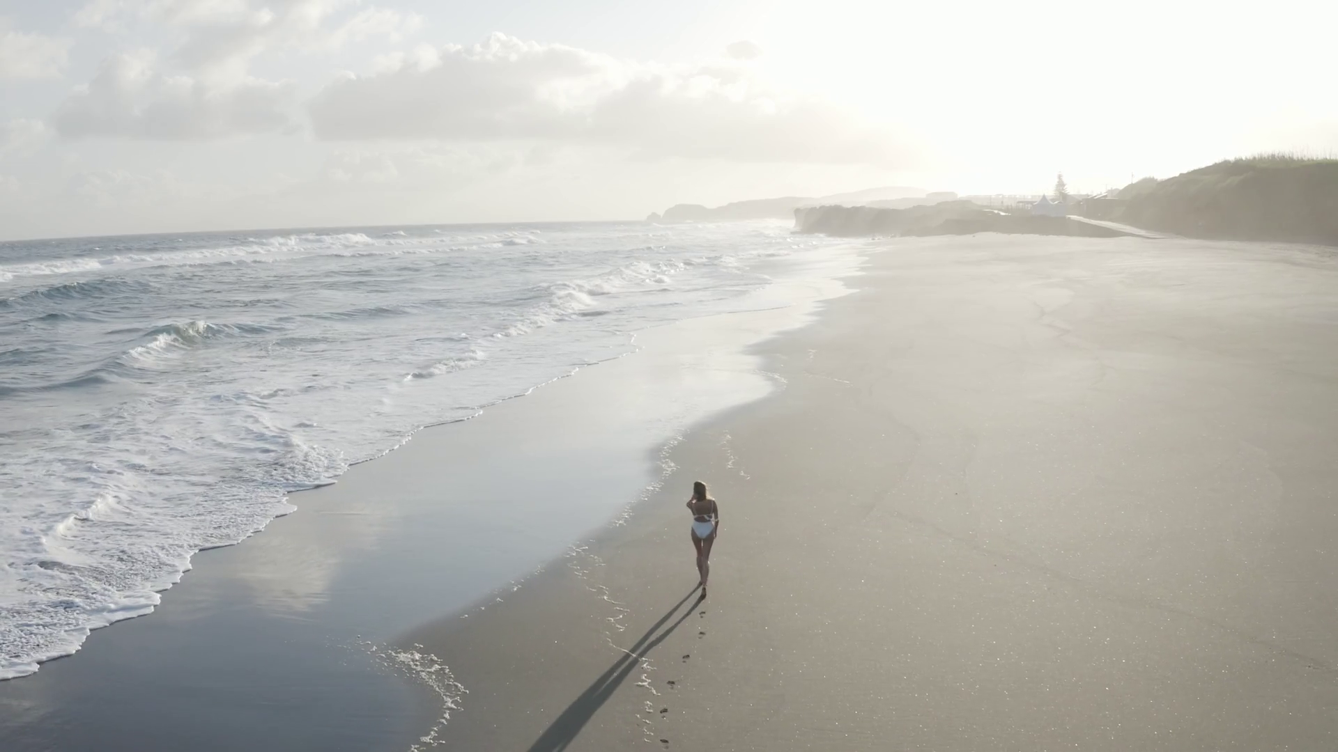 Aerial View of woman walking along the beach, Praia do Areal de Santa Barbara, Ribeira Seca Aerial View of woman walking along the beach, Praia do Areal de Santa Barbara, Ribeira Seca