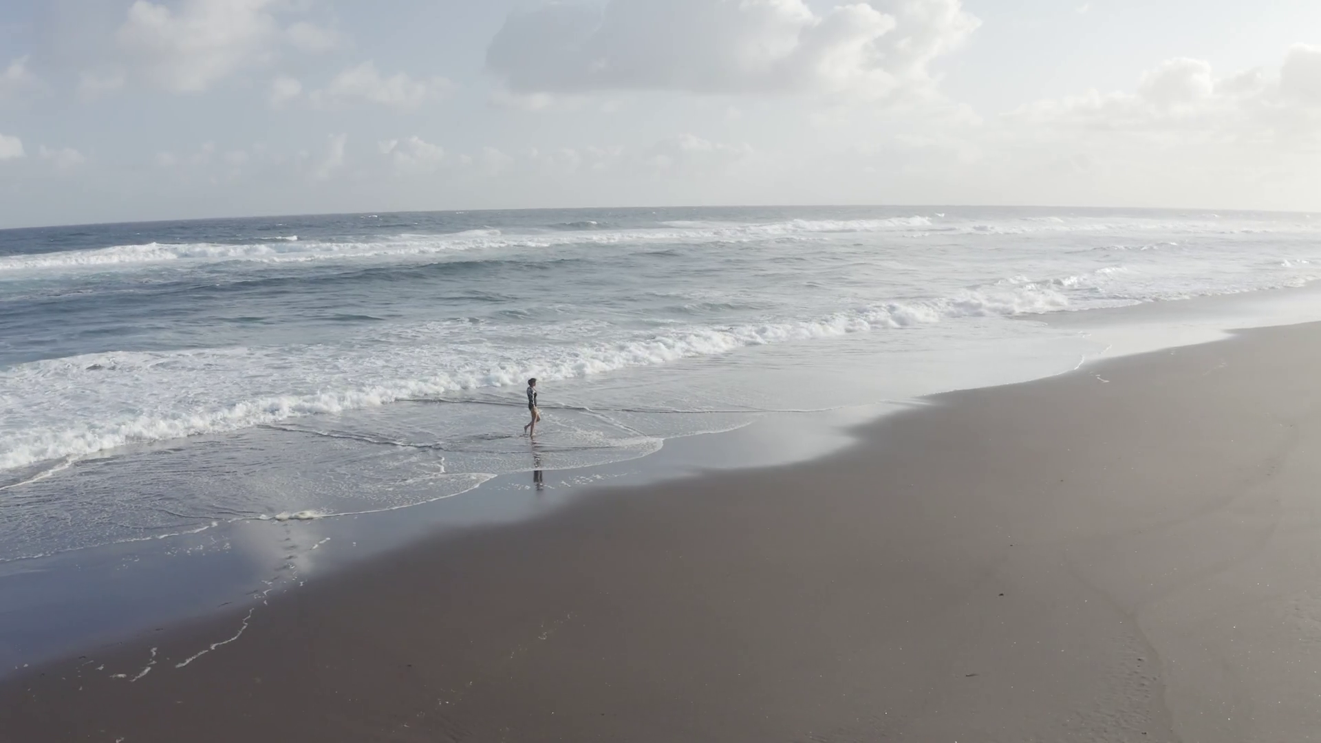 Aerial View of woman walking along the beach, Praia do Areal de Santa Barbara, Ribeira Seca Aerial View of woman walking along the beach, Praia do Areal de Santa Barbara, Ribeira Seca