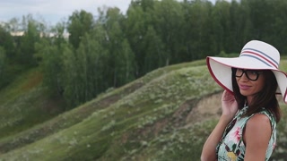 Magical and mystic girl looking to the coast from a cliff in Iceland