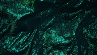 Shimmering, emerald-green surface with textured folds. The metallic sheen and intricate ridges suggest a luxurious, almost otherworldly material