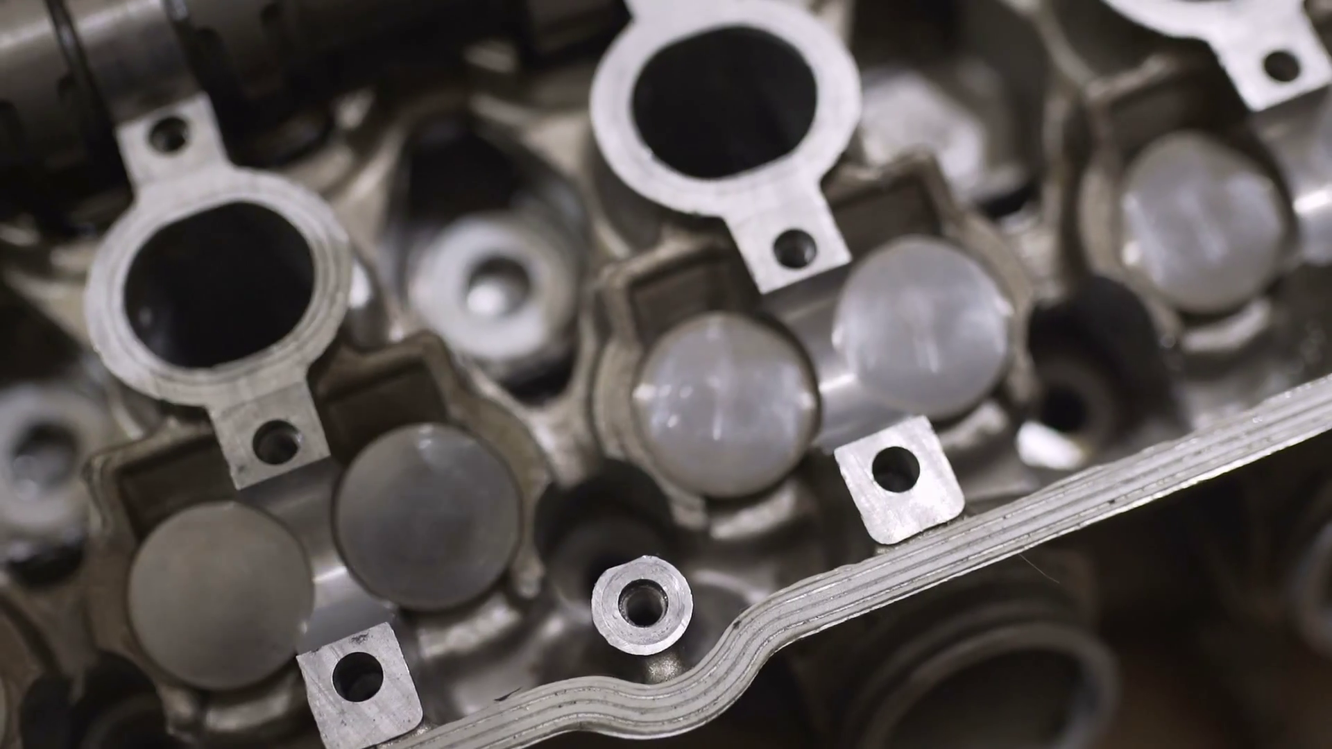 The mechanic man repairs broken engine head, replaces the camshaft