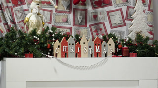 Display of Christmas decorations with houses and festive items on a table