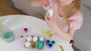 Coloring Easter eggs with joy and creativity in a cozy home setting
