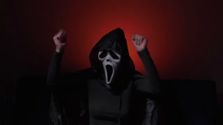 Chilling Halloween evening with a mysterious figure in a haunting cloak