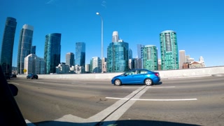 Driving through modern San Francisco skyscrapers on a sunny day