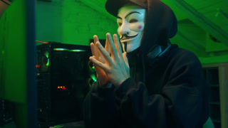Lviv, Ukraine - June 03, 2024: Hacker man anonymous dangerous computer pc criminal stealing information online datum hooded mysterious