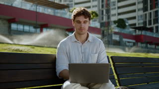 Caucasian man sitting talking conversation dialogue laptop computer online meet conference video calling blog businessman employee worker