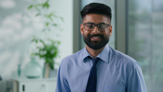 Portrait in office happy smiling Arabian ethnic Muslim business man Indian businessman looking at camera carefree positive male professional