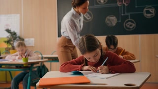 Back to school multiracial children studying primary knowledge education in class lesson Caucasian boy raising arm asking for help woman