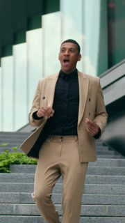 Successful excited African American business man running on office stairs celebrating win outside city building male businessman guy showing