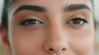 Close up Indian Muslim woman eyes looking at camera with long eyelashes beauty makeup eyeliner mascara natural look Arabian female clinic