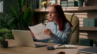Worried Caucasian business woman talking laptop online call reviewing loss chart analyzing sales data computer in office sad businesswoman