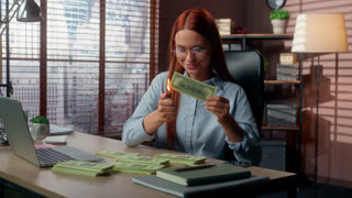 Smiling Caucasian business woman entrepreneur burning money with fire in office happy businesswoman smile burn cash enjoying wealth female