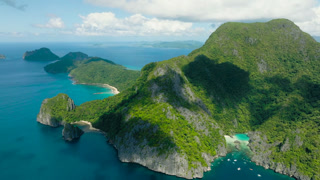 Beaches and Cadlao Lagoon with turquoise water. El Nido. Blue sky and clouds. Palawan, Philippines.