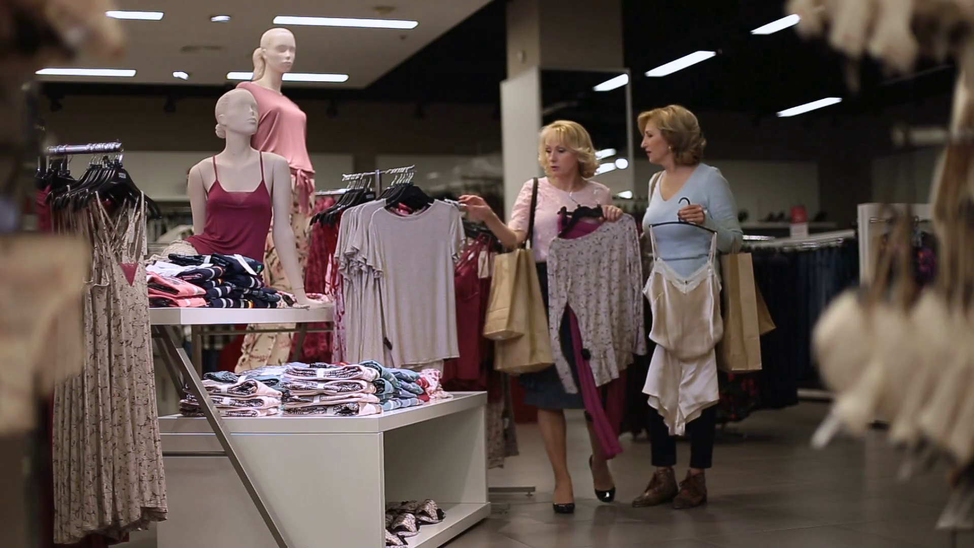 Beautiful women shopping for clothes at store Stock Video Footage 0017