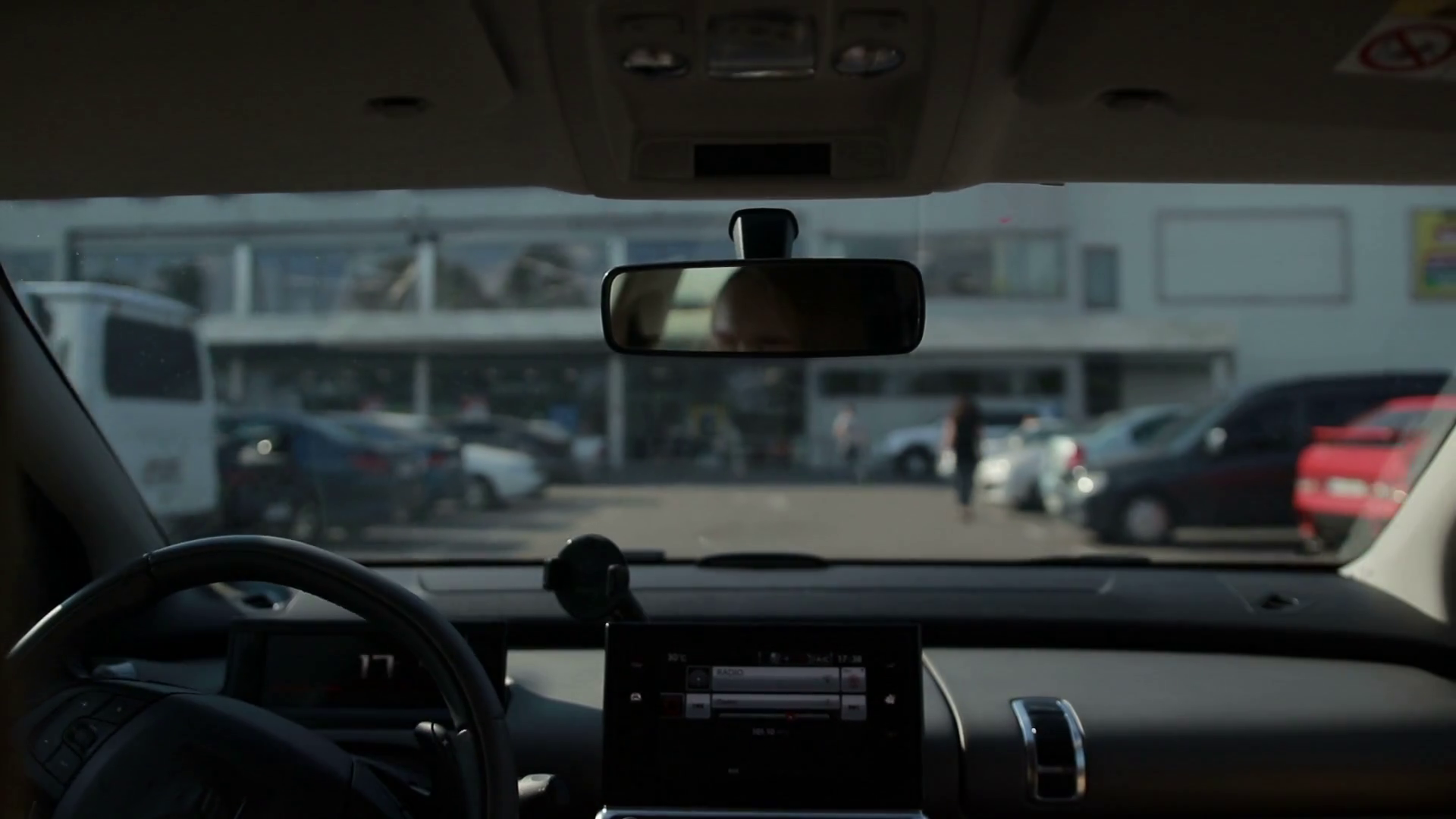 Car leaving parking lot near shopping centre Stock Video Footage 0018