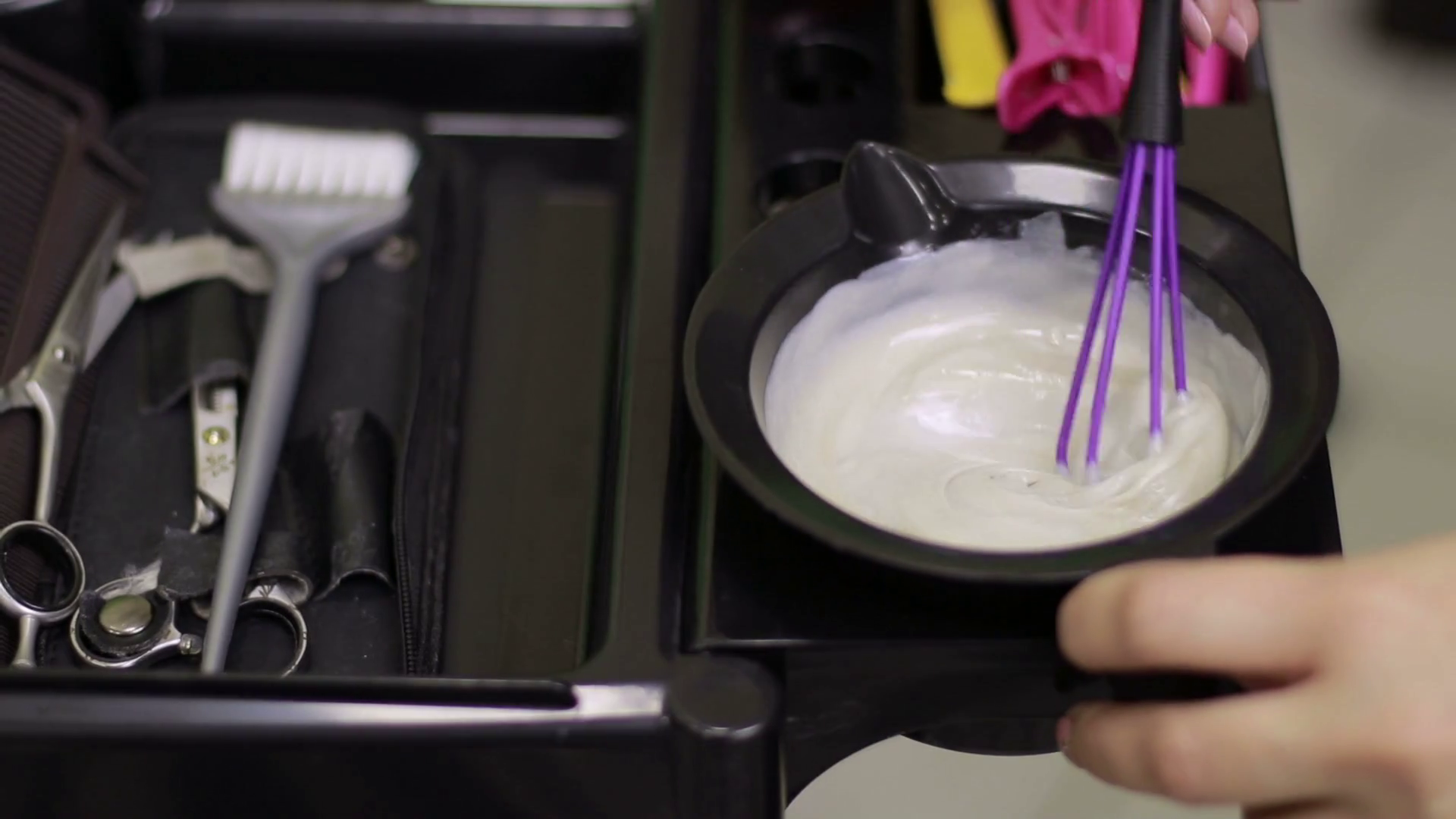 Hairdresser mixing hair dye in bowl in hair salon Stock Video Footage